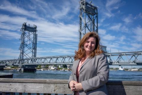 Erin Bell standing in front of bridge